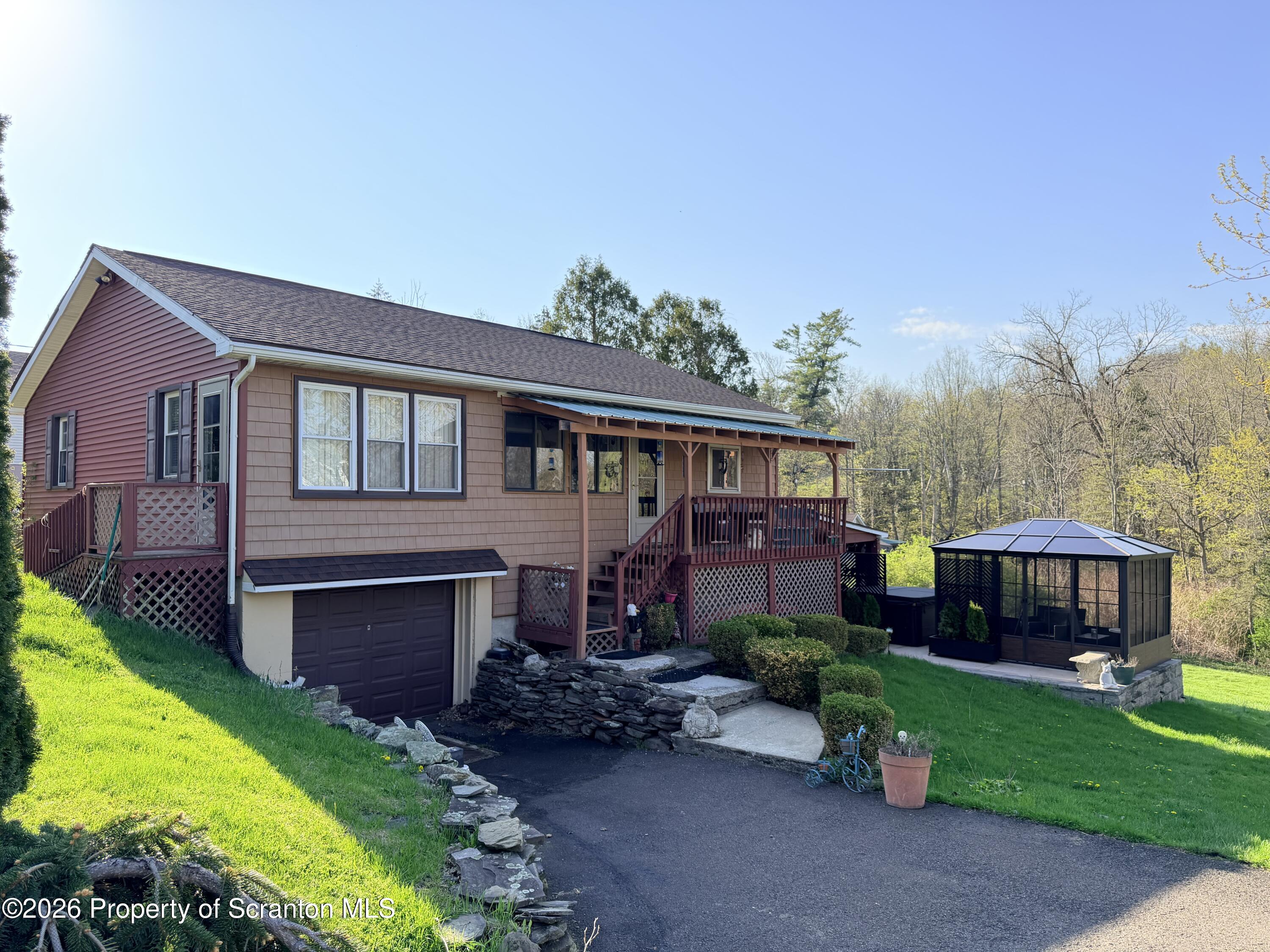 338 Bailey Street Clarks Summit, PA 18411 - Photo 1 of 24 a view of a house with a garden and pathway