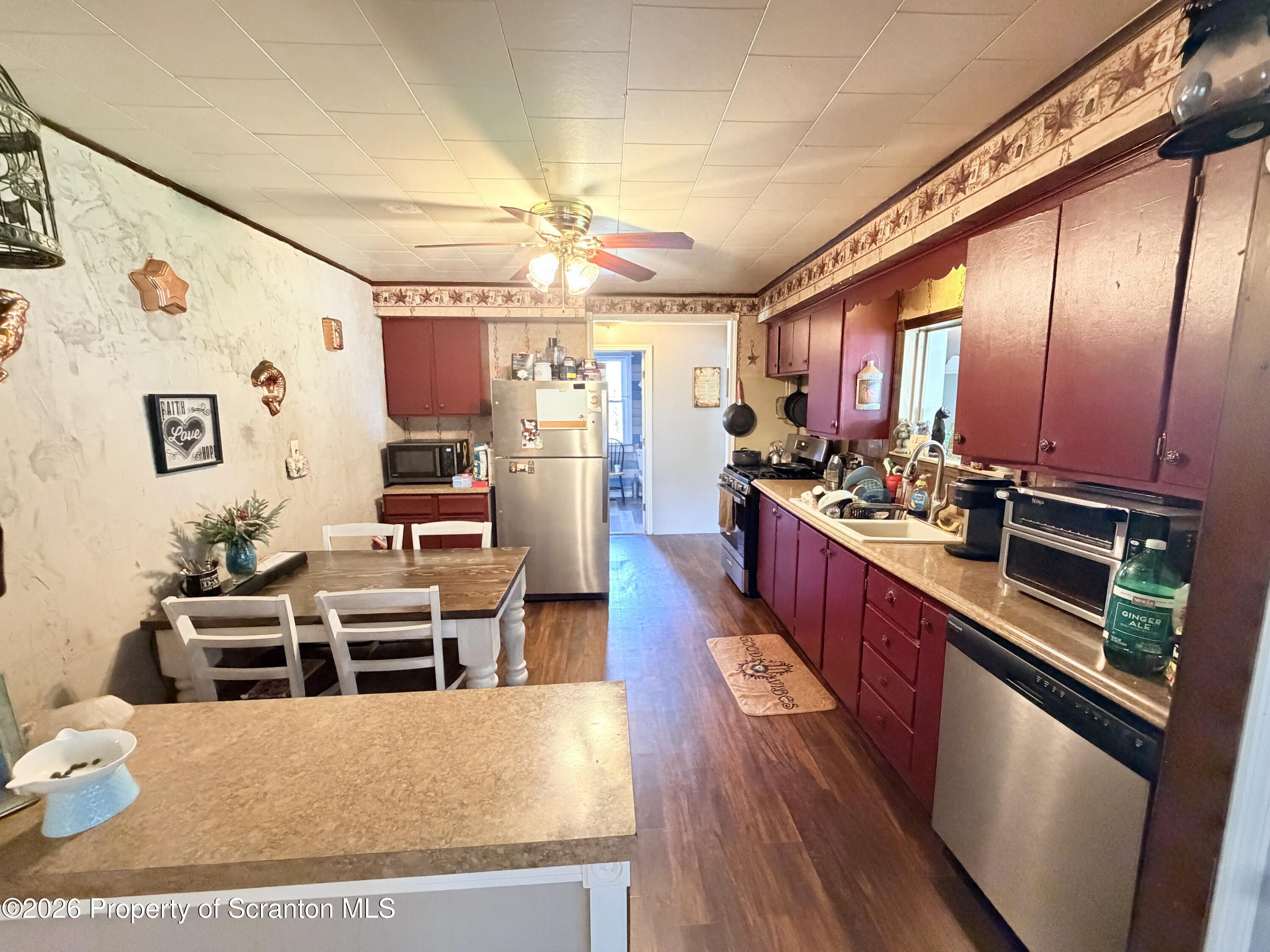 338 Bailey Street Clarks Summit, PA 18411 - Photo 12 of 24 a large kitchen with a table and chairs