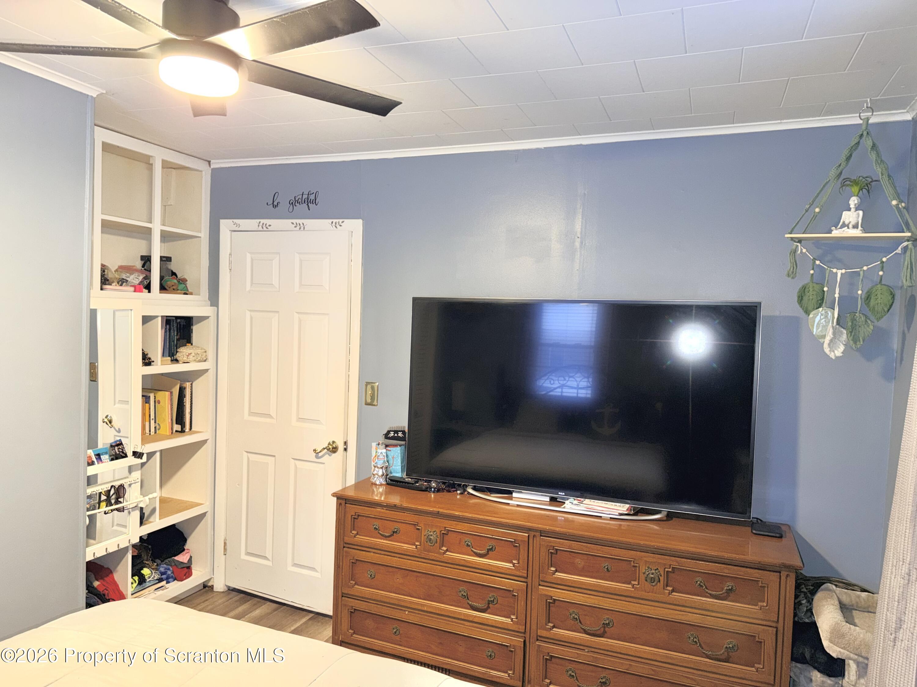 338 Bailey Street Clarks Summit, PA 18411 - Photo 14 of 24 a living room with flat screen tv and gym equipment