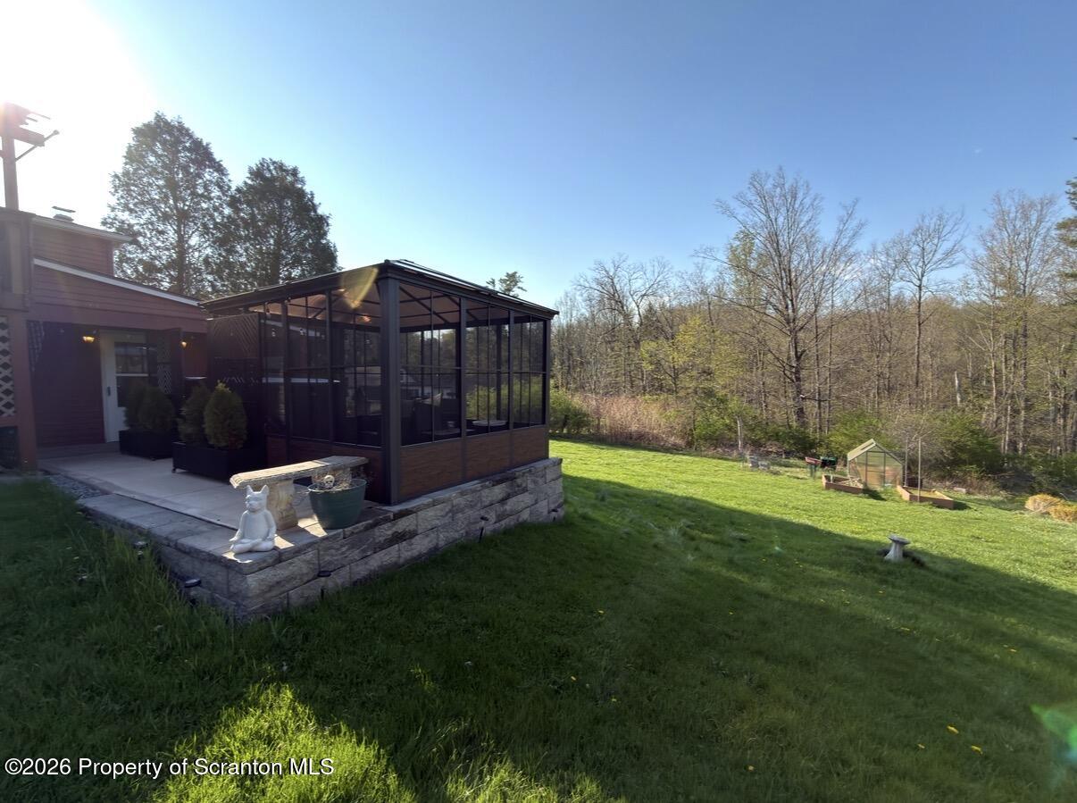 338 Bailey Street Clarks Summit, PA 18411 - Photo 2 of 24 a view of a backyard with a garden and entertaining space