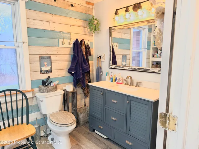 a bathroom with a sink vanity mirror and toilet