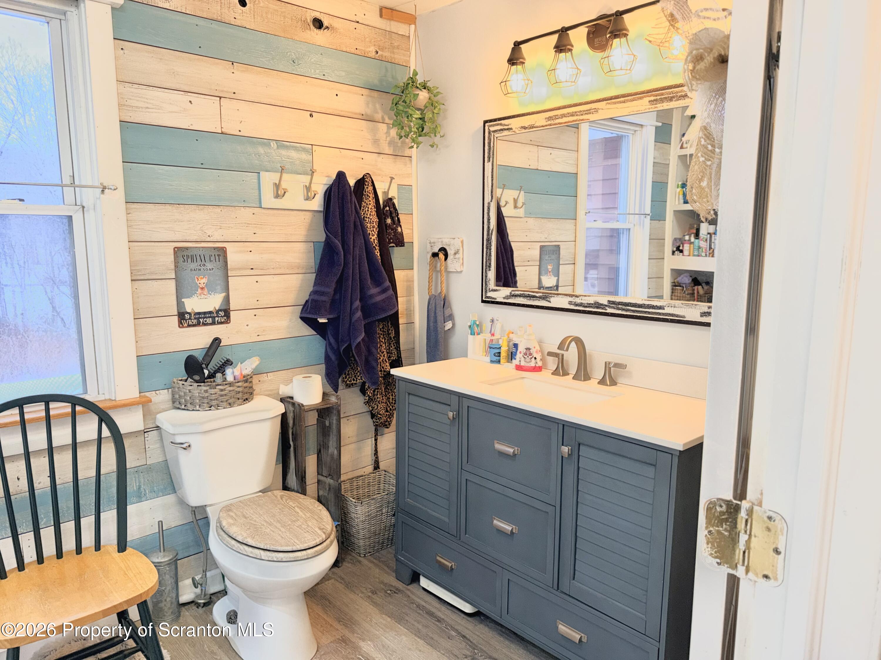 338 Bailey Street Clarks Summit, PA 18411 - Photo 8 of 24 a bathroom with a sink vanity mirror and toilet