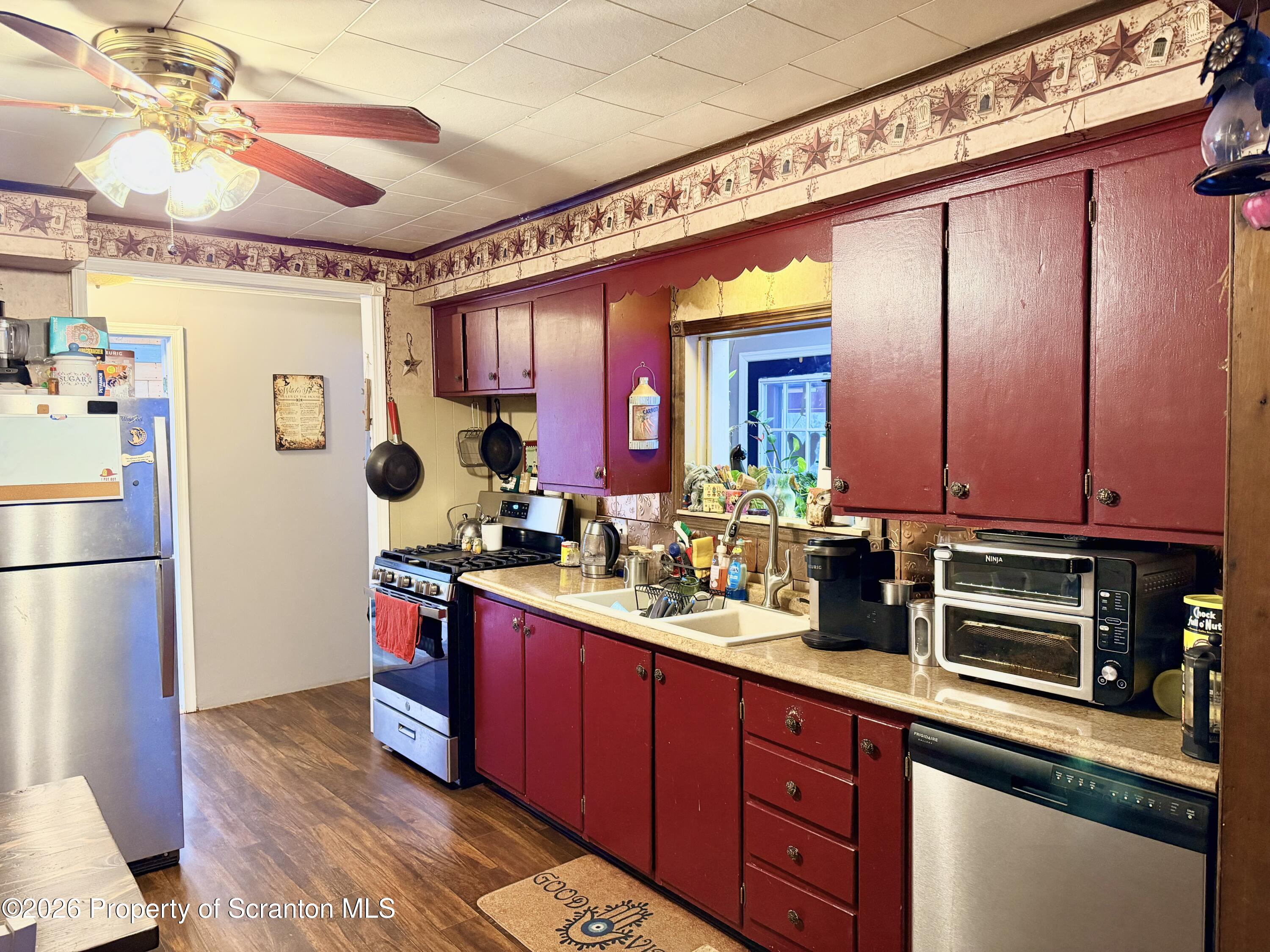 338 Bailey Street Clarks Summit, PA 18411 - Photo 10 of 24 a kitchen with refrigerator and cabinets