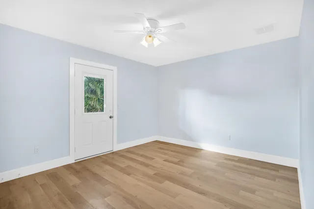 wooden floor in an empty room with a window