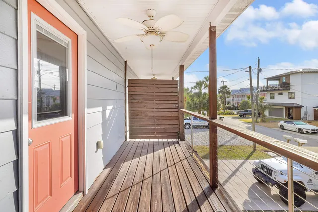 a view of balcony with a large window and wooden floor