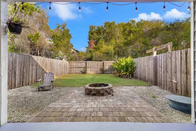 a white house that has tree in front of it