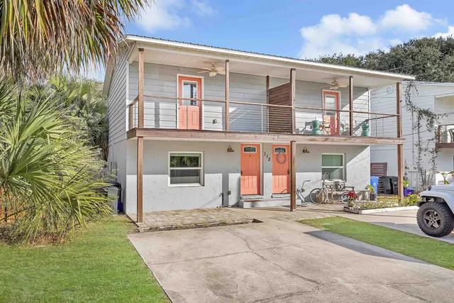 a couple of cars parked in front of a house