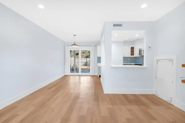 wooden floor in an empty room with a window