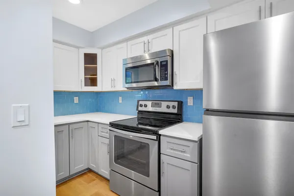 a kitchen with a refrigerator sink and microwave