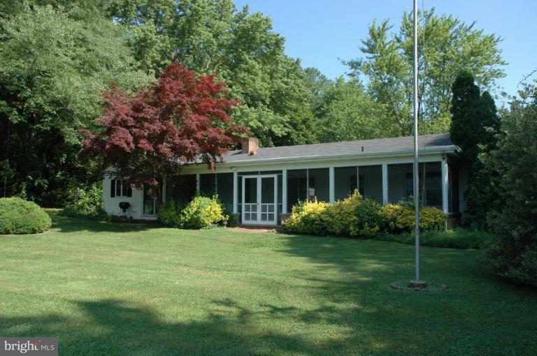 24611 Long Haul Road St. Michaels, MD 21663 - Photo 1 of 16 a front view of house with a garden and patio