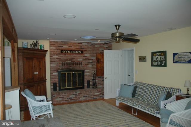 24611 Long Haul Road St. Michaels, MD 21663 - Photo 2 of 16 a living room with furniture and a fireplace