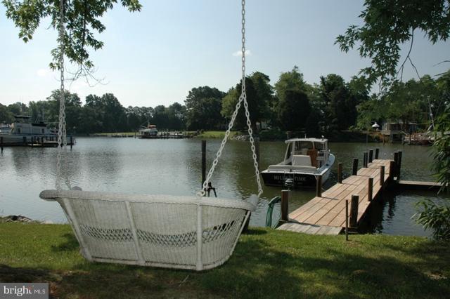 24611 Long Haul Road St. Michaels, MD 21663 - Photo 11 of 16 a view of a lake with couches chairs and a table