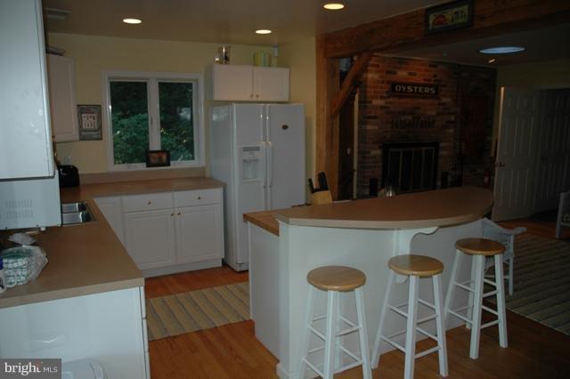 24611 Long Haul Road St. Michaels, MD 21663 - Photo 13 of 16 a kitchen with stainless steel appliances granite countertop a kitchen island a stove a sink and a refrigerator