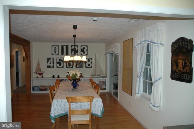 24611 Long Haul Road St. Michaels, MD 21663 - Photo 15 of 16 a view of a dining room with furniture and chandelier