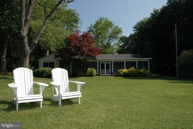 24611 Long Haul Road St. Michaels, MD 21663 - Photo 4 of 16 a view of a house with backyard sitting area and garden