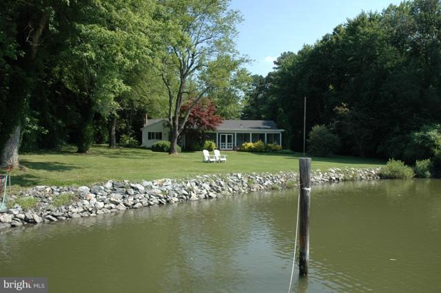 24611 Long Haul Road St. Michaels, MD 21663 - Photo 7 of 16 a view of a lake with a house in the background