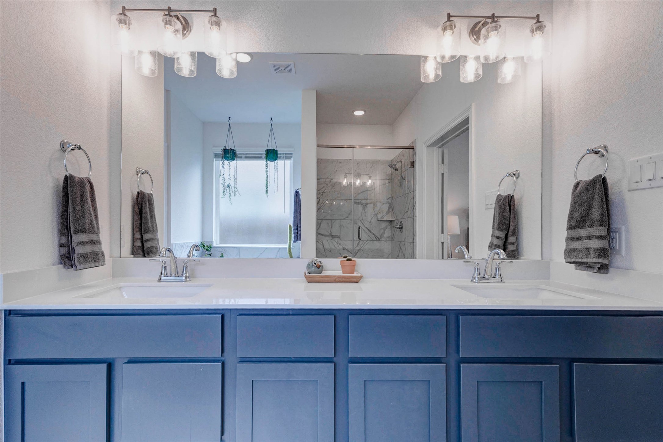 32418 Fly Fish Way Fulshear, TX 77441 - Photo 19 of 40 With generous counter space, ample cabinet storage below, and a large mirror that reflects the natural light, getting ready each morning will feel anything but ordinary.