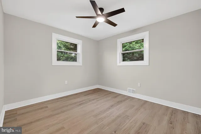 wooden floor in an empty room with a window