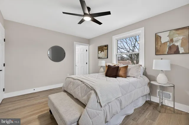 a bedroom with a bed and a painting on the wall