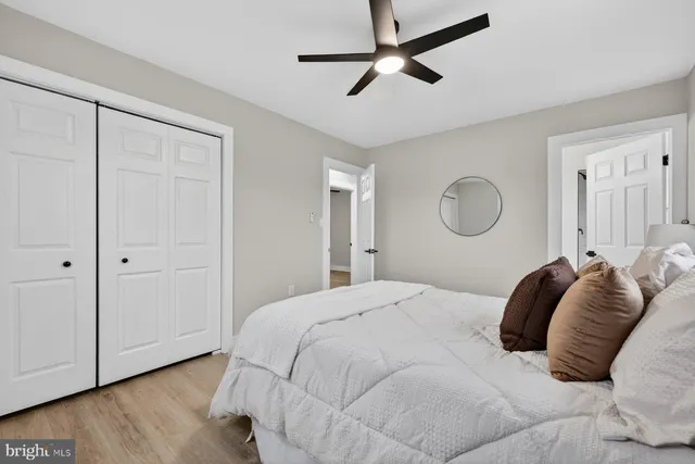 a bedroom with a large bed and wooden floor