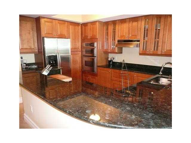 821 North Riverside Drive, Unit 903 Pompano Beach, FL 33062 - Photo 3 of 17 a kitchen with sink a window and a counter top space