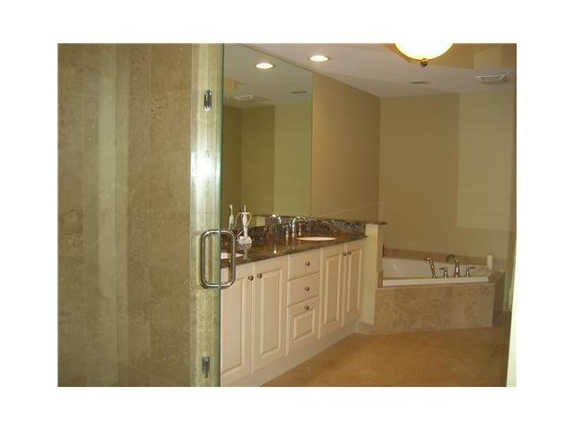 821 North Riverside Drive, Unit 903 Pompano Beach, FL 33062 - Photo 7 of 17 a bathroom with a sink and a mirror