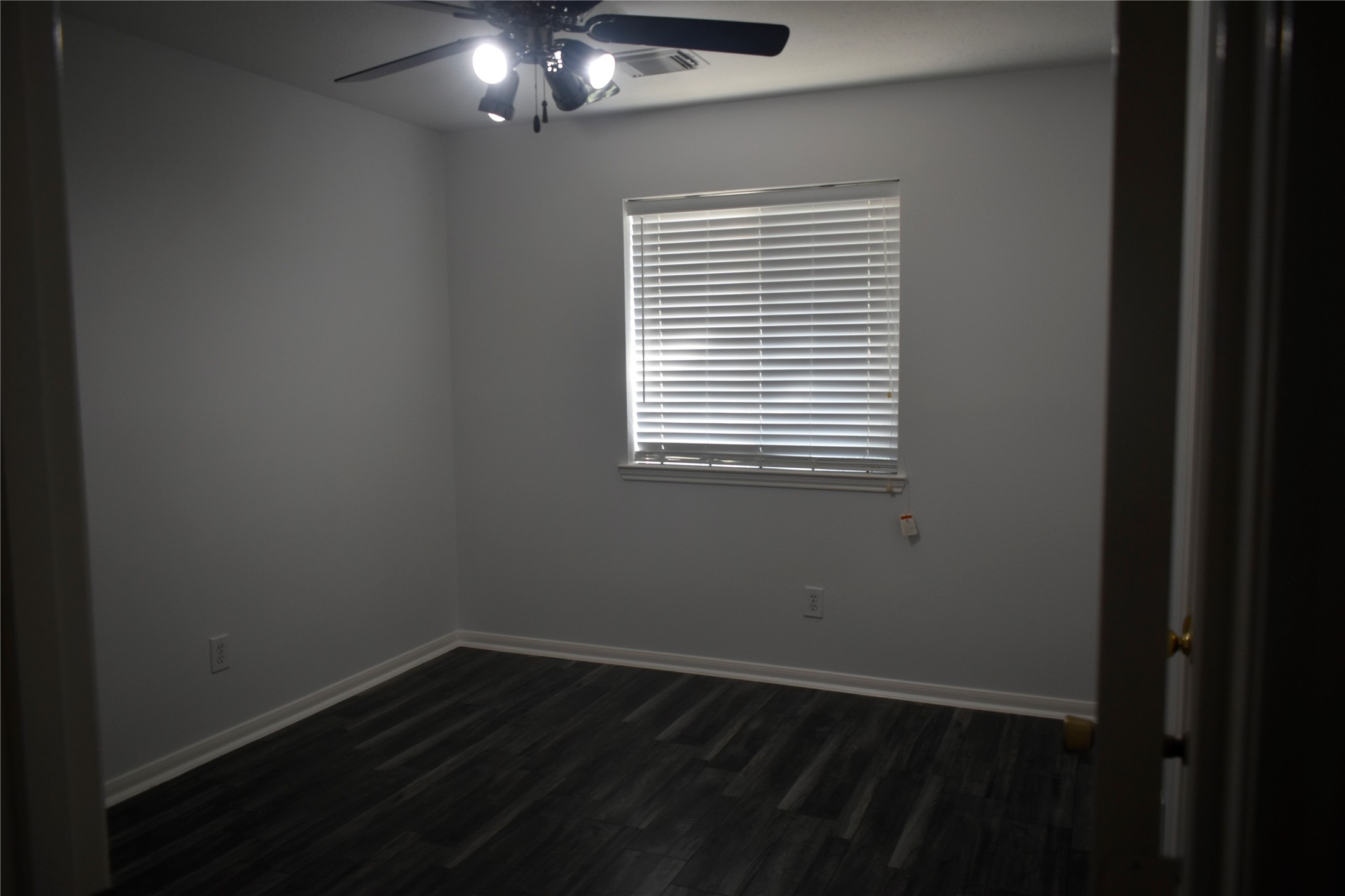 507 Springhope Court Houston, TX 77049 - Photo 12 of 18 a view of an empty room with wooden floor and a window