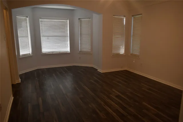 a view of wooden floor and windows in a room