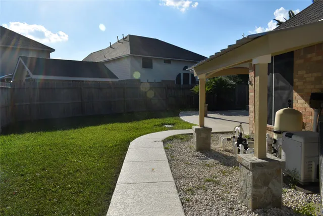 a backyard of a house with table and chairs