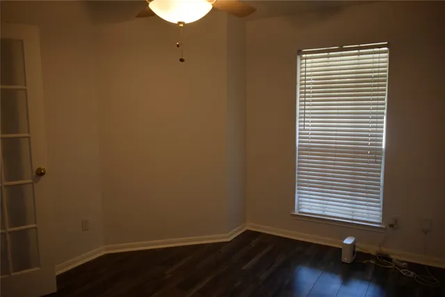 a view of a room with wooden floor and a window