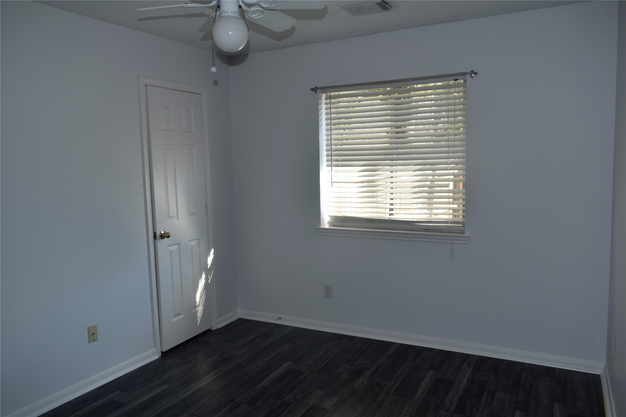 507 Springhope Court Houston, TX 77049 - Photo 10 of 18 a view of an empty room with wooden floor and a window