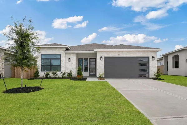 a front view of house with yard and green space