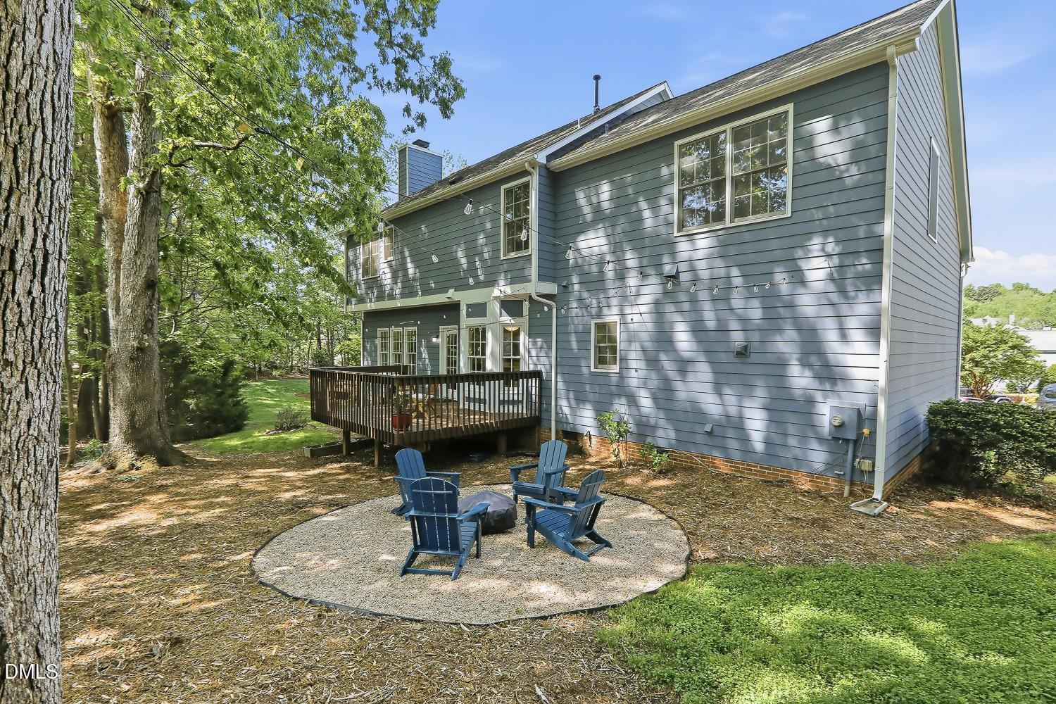 4001 Batiste Road Raleigh, NC 27613 - Photo 52 of 63 a backyard of a house with fountain table and chairs