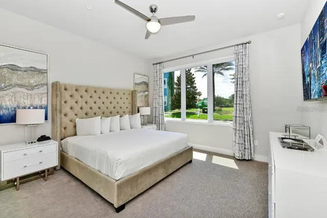 a large bedroom with a bed and a window