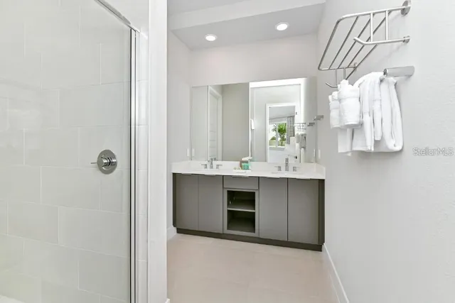 a bathroom with a sink a mirror and a shower