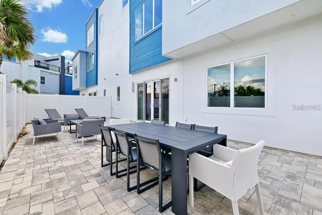 a outdoor dining space with furniture and a potted plant