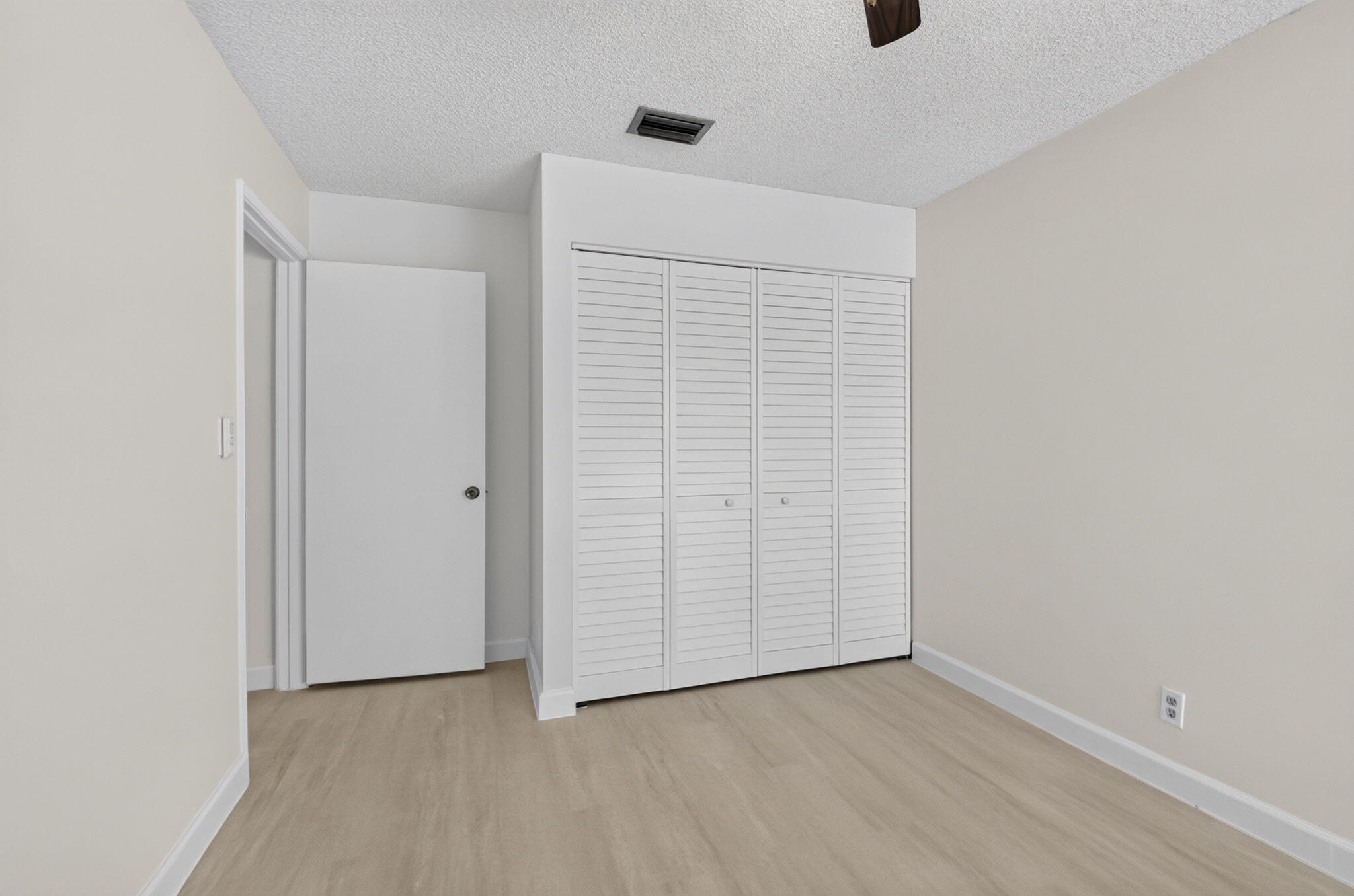 21070 Woodspring Avenue Boca Raton, FL 33428 - Photo 24 of 30 an empty room with wooden floor