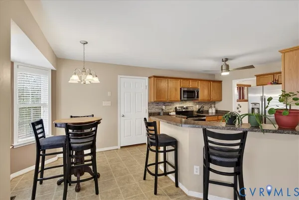a dining room with furniture and window