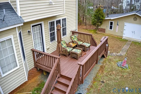 an aerial view of a house with swimming pool and porch