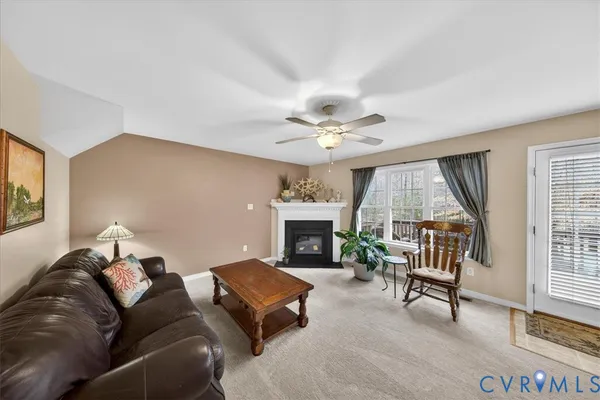 a view of a dining room with furniture and a chandelier