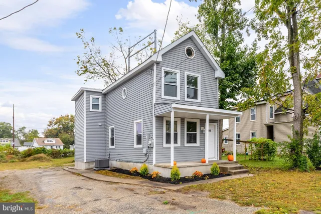 a front view of a house with a porch and garage