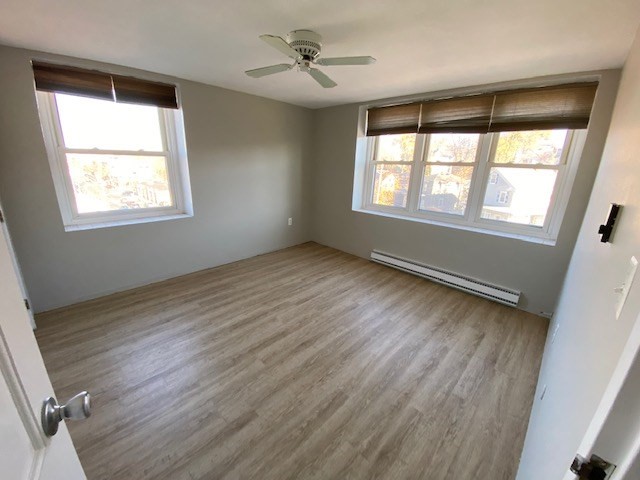 340 Main Street, Unit 501 Melrose, MA 02176 - Photo 4 of 11 a view of an empty room with wooden floor and a window