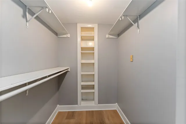 a view of walk in closet with empty racks