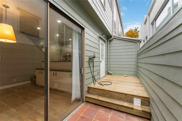a view of a balcony with a barbeque