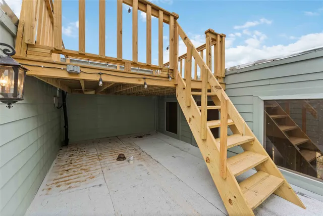 a view of a balcony with wooden floor and city view