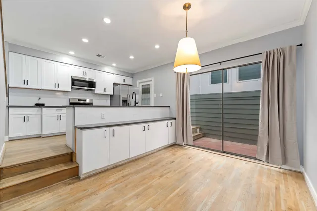 a open kitchen with kitchen island a sink stainless steel appliances and cabinets