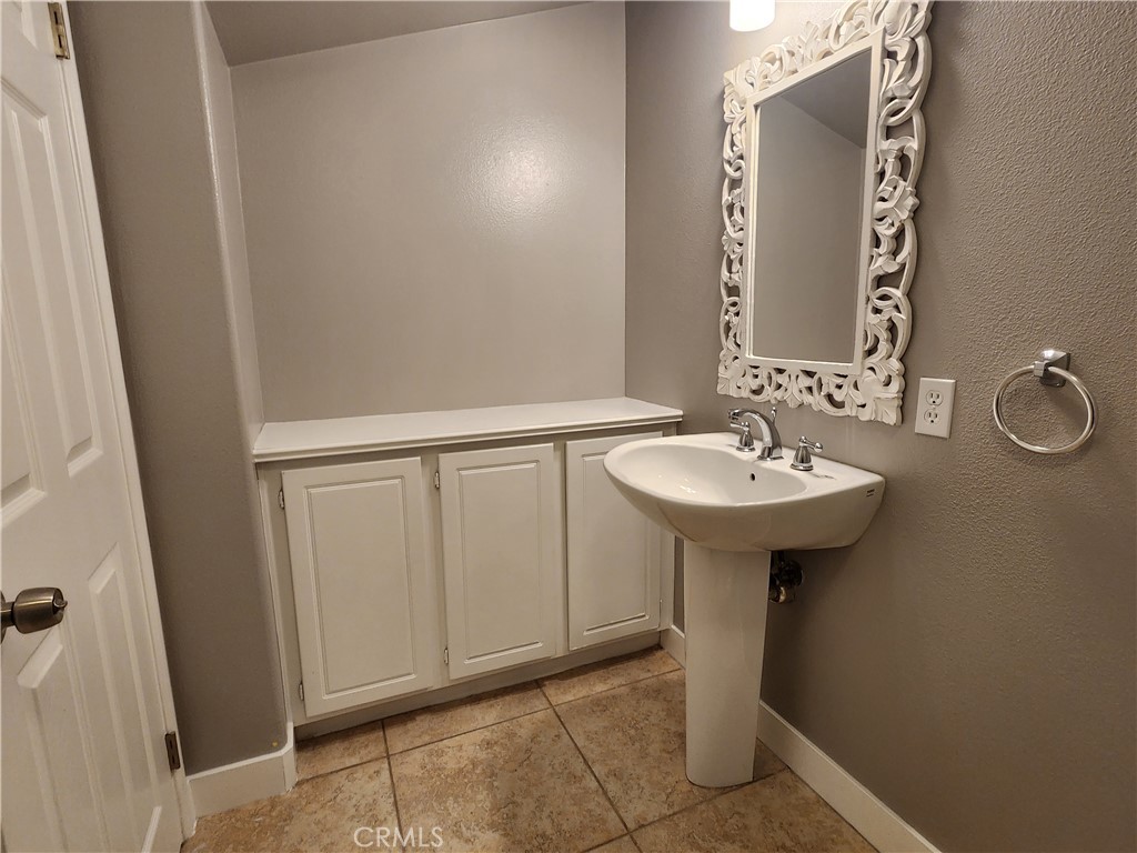 1 Arabis Way, Unit 59 Ladera Ranch, CA 92694 - Photo 15 of 32 a bathroom with a sink and a mirror