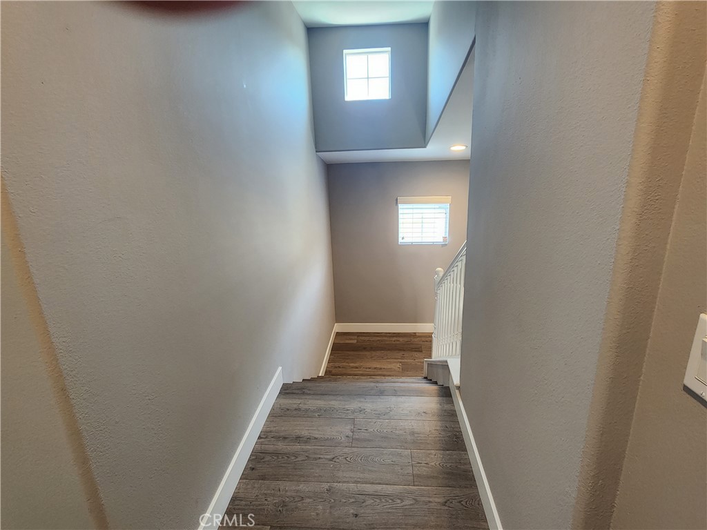 1 Arabis Way, Unit 59 Ladera Ranch, CA 92694 - Photo 19 of 32 a view of a hallway with wooden floor and entryway