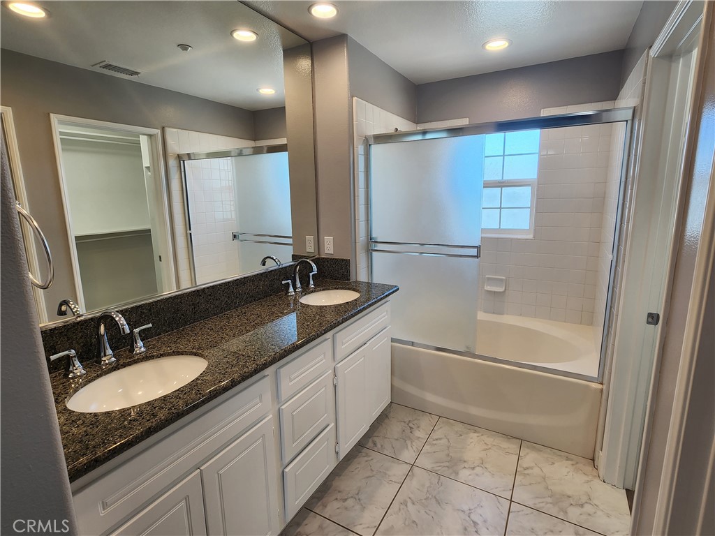 1 Arabis Way, Unit 59 Ladera Ranch, CA 92694 - Photo 27 of 32 a bathroom with a granite countertop sink mirror and a bathtub