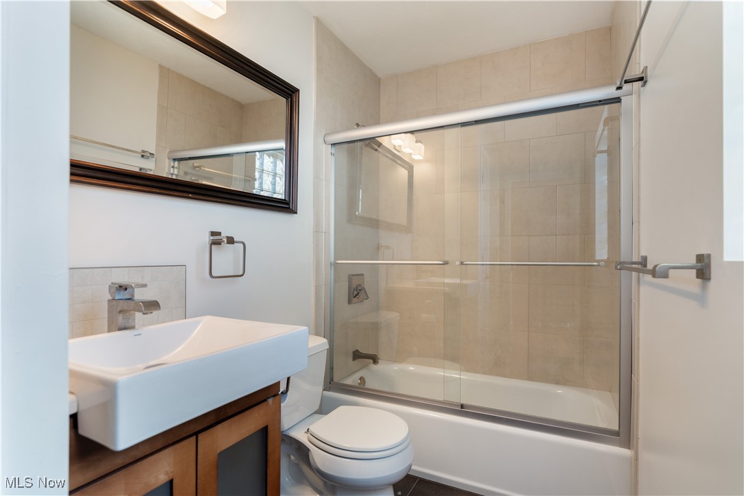 711 University Road Cleveland, OH 44113 - Photo 26 of 36 Full bathroom with vanity, enclosed tub / shower combo, and toilet